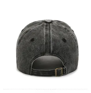 Detail of adjustable metal buckle and washed denim texture on dark grey baseball cap