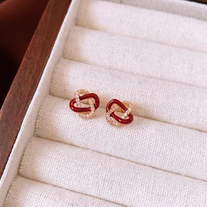 Cross knot stud earrings in red enamel and gold plating with pavé cubic zirconia