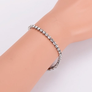 Elegant single row rhinestone bracelet in silver stainless steel on a model's wrist