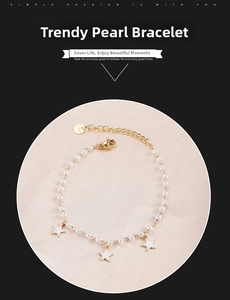 Detailed macro view of gold-plated stainless steel pearl bracelet with star charms