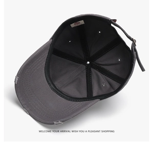 Detailed interior of a distressed grey baseball cap with stitching and metal buckle
