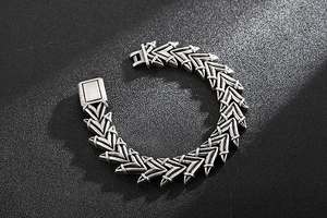 Close-up of vintage silver punk skull bracelet with arrow-shaped bone link structure