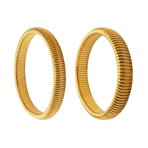 Minimalist gold industrial style tubogas hoop earrings with textured metal surface