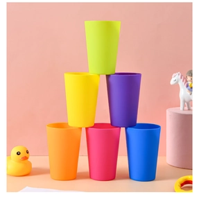 Close-up of colorful plastic stacking cups in a tower with child-friendly bath toy decor