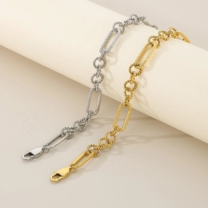 Stylish twisted geometric paperclip chain bracelet set in polished gold and silver steel