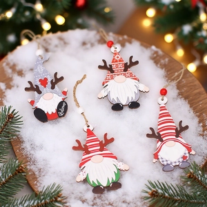 Wooden Christmas gnome ornaments set with reindeer antlers on a snowy background