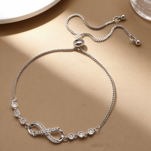 Macro shot of silver infinity bracelet with micro-pave Daughter lettering and box chain