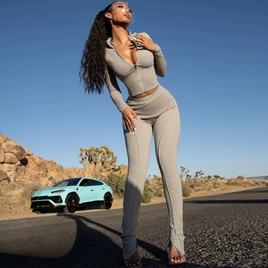 Detail of grey ribbed knit texture on zip-up jacket and split-hem leggings yoga set