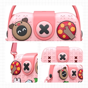 Pink cartoon silicone children's handbag with decorative charms and adjustable shoulder strap