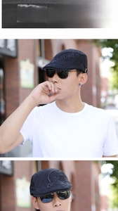 Detail of black cotton beret showing quilted texture and side embroidery on male model