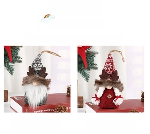 Close-up of two Christmas gnomes with grey and red snowflake hats and wooden button detail