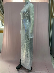 Detail of silver sequin fabric on a slim fit maxi dress with high neck and long sleeves