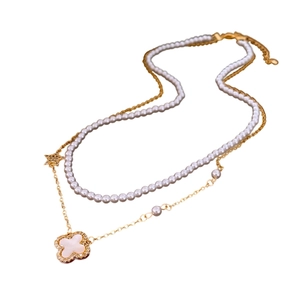 Double-layered gold chain necklace with white pearls and clover flower pendant