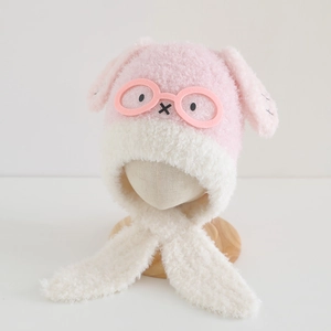 Close-up of pink and cream plush bear hat with cute long ears and glasses accessory