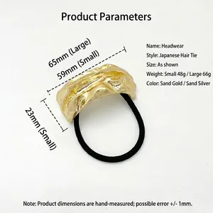 Japanese style U-shaped hair tie with textured sand gold metal ornament on elastic band