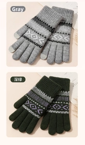 Detailed close-up of grey and dark green knitted winter gloves with Nordic jacquard texture