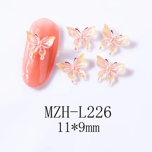 Detail of 11x9mm 3D butterfly nail charms in translucent pink resin with glitter