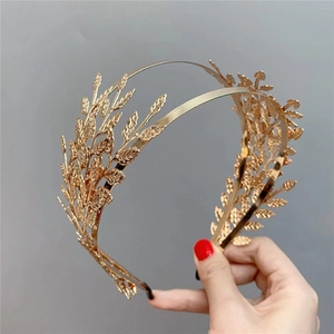 Detailed close-up of golden metal double-row leaf headband for weddings and elegant events