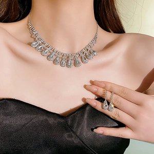 Detail of silver necklace and earring set with shimmering drop-shaped rhinestones