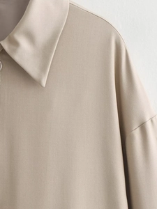 Macro shot of the beige baseball jacket collar and shoulder with woven texture