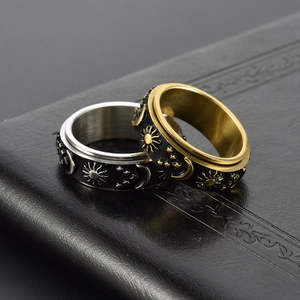 Detail of gold and silver spinner rings with sun, moon, and star relief carvings
