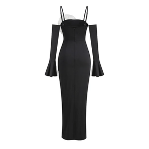 Detail of off-shoulder flared sleeves and white 3D floral accent on black dress back
