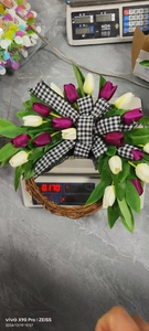 Detailed view of artificial tulip wreath showing 0.170kg weight on a digital scale