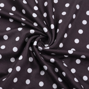Macro shot of V-neck polka dot dress fabric showing soft texture and drape quality