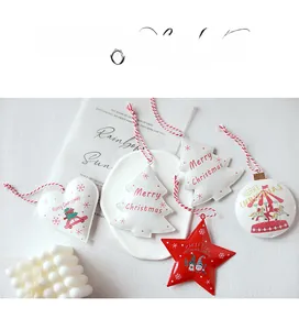 Flat lay of retro metal Christmas ornaments with white and red holiday patterns