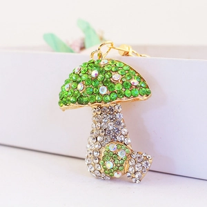 Colorful mushroom keychain with green iridescent rhinestones and gold-tone metal base