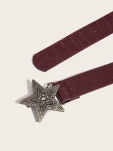 Detail of vintage burgundy belt with crocodile pattern and star-shaped metal buckle