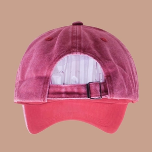 Detail view of the vintage wine red washed cotton baseball cap with adjustable metal buckle