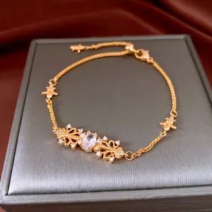 Exquisite gold iris flower bracelet with central zircon on dark jewelry display box
