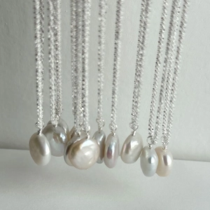 Close-up of S925 silver necklace with shimmering baroque pearls showing natural texture
