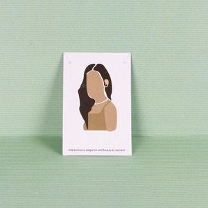 Close-up of green round stud earrings on a minimalist white portrait display card