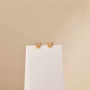 Detail of 18K gold plated heart earrings with sparkling cubic zirconia inlay
