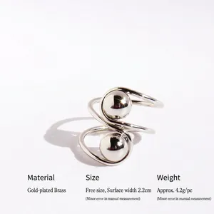 Minimalist silver S-curve spiral ring with polished spheres in brass gold plating