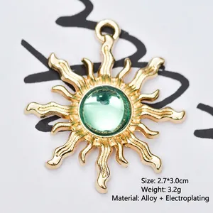 Detailed view of a 2.7x3.0cm golden sun-shaped alloy pendant with a green gemstone inlay