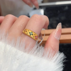Detailed macro view of 24k gold plated floral ring with colorful zircon inlay texture
