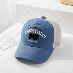 Detail of blue and white kids mesh cap with embroidered lettering and breathable texture