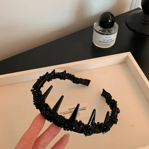 Black mesh wrapped crystal headband with punk spikes for a high crown voluminous hairstyle