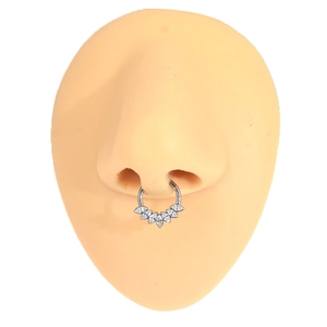 Macro detail of F136 titanium septum ring with marquise zircon stones on a model's nose