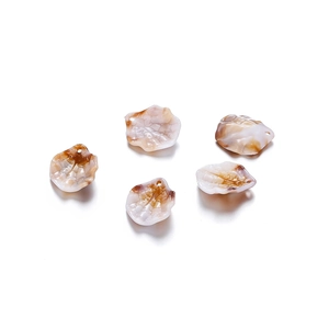 Macro shot of tortoiseshell acrylic leaf pendants with pre-drilled holes for DIY jewelry