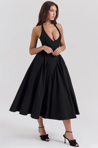 Detail view of the elegant deep V-neck halter dress with pleated waist and voluminous skirt