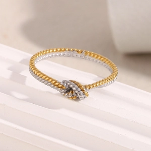 Macro shot of two-tone twisted knot ring in 18K gold and silver stainless steel