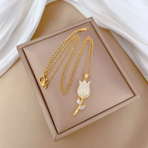 Detailed macro view of the gold-plated tulip pendant with faux mother-of-pearl petals