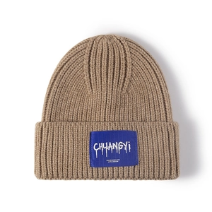 Minimalist khaki knitted beanie with blue logo patch for stylish outdoor winter warmth