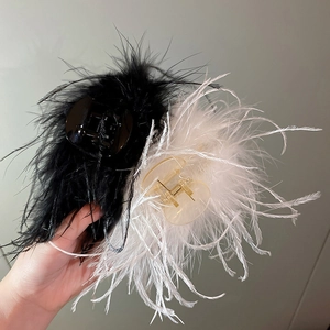 Detail of elegant black and white ostrich feather hair claws for sophisticated styling