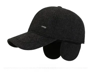 Close-up of deep grey woolen winter baseball cap featuring integrated ear flaps and tag