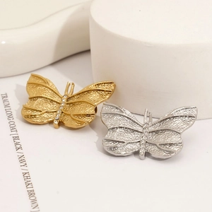 Elegant butterfly brooches in gold and silver with hammer-texture finish and crystal inlay